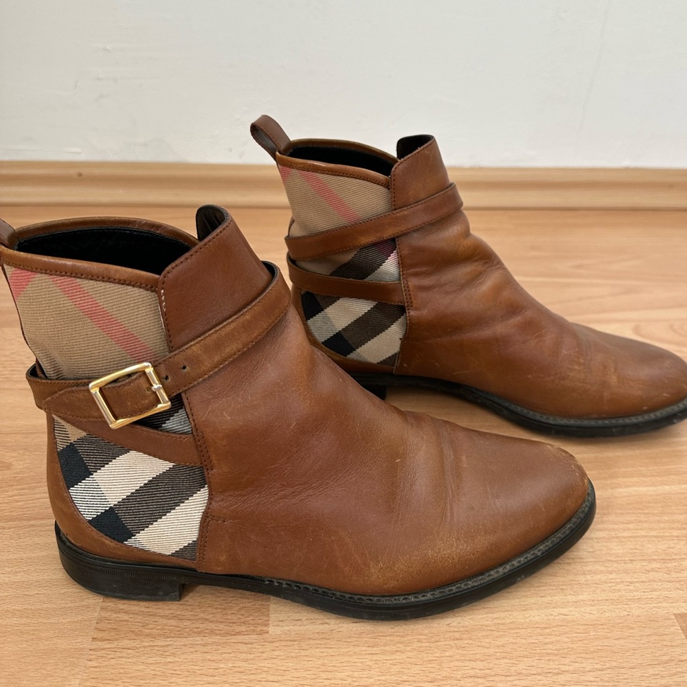 Burberry leather ankle boots with belt detail.